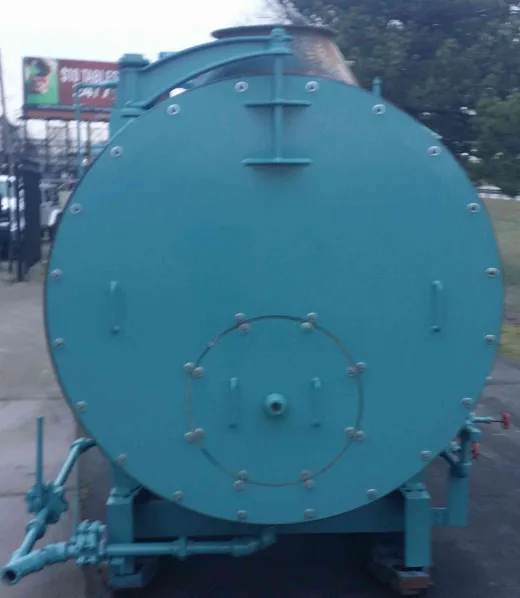 Rear head and manway of a refurbished firetube steam boiler with blowdown piping